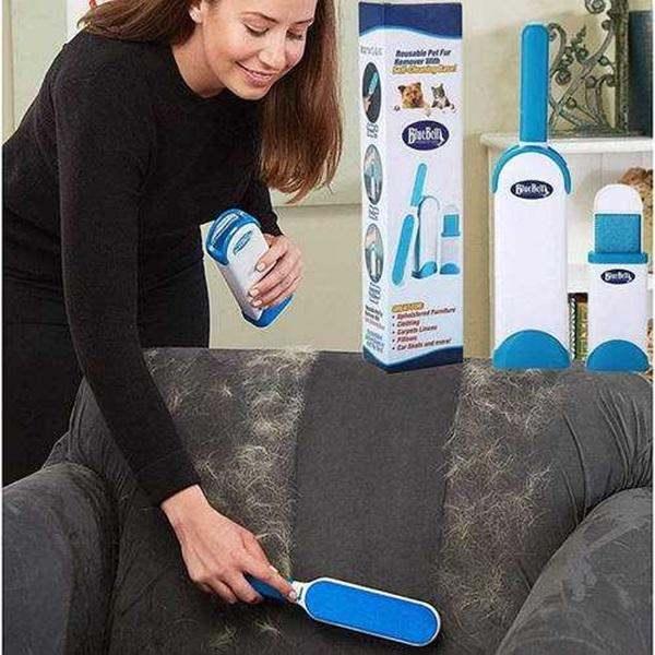 Reusable Dog and Cat Fur Remover tool being used on a fabric sofa to pick up pet hair.