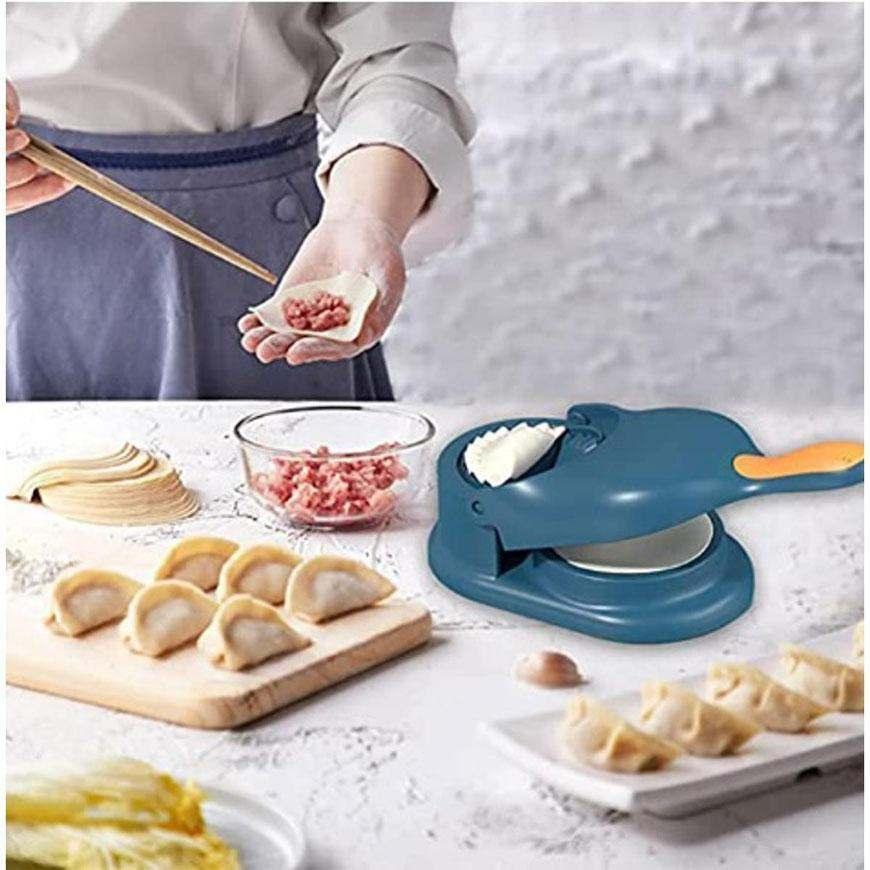 Blue ABS plastic dumpling wrapper tool with freshly made dumplings and meat filling on kitchen countertop