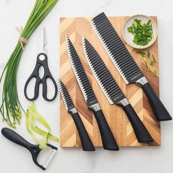 6-piece wave pattern sharp chef's knife set with black handles on wooden cutting board