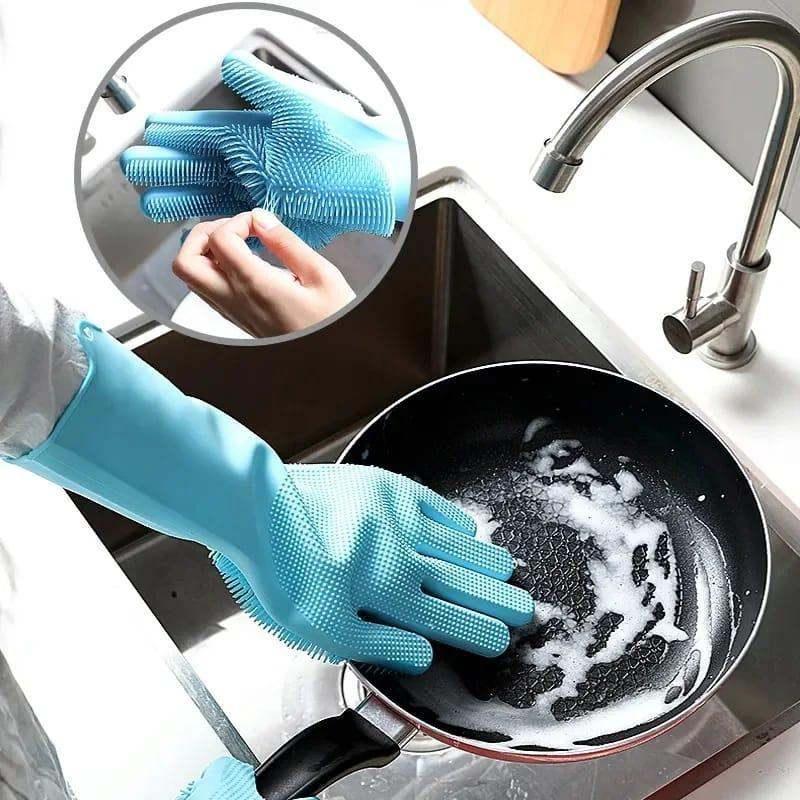 Blue automatic dish washing gloves with built-in silicone bristles cleaning a soapy frying pan in kitchen sink